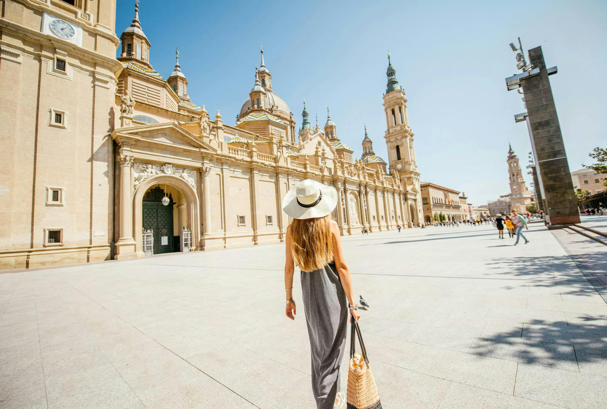 Woman walking through a town square in Spain